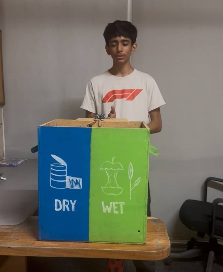 A learner presenting SegreSmart, a bin divided into dry and wet sides